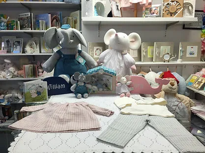 Hand-knit baby sweaters with plush friends