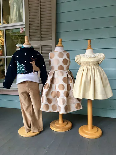 Navy reindeer sweater, gold-dot party dress and cream smocked dress