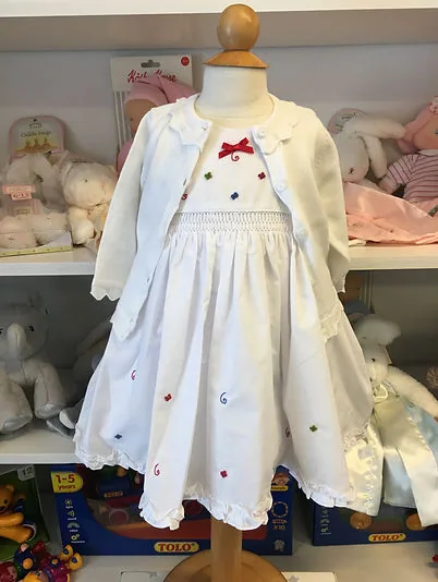 White dress with embroidered cherries and a red bow